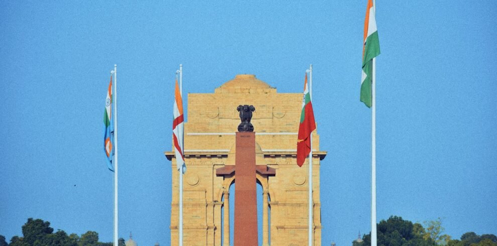 a clock tower with flags flying in front of it