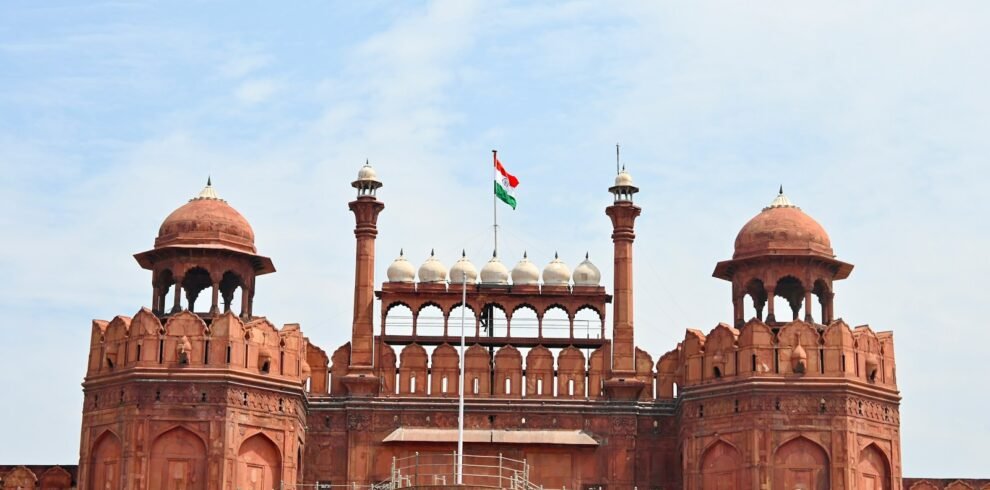 a large building with two towers and a flag on top